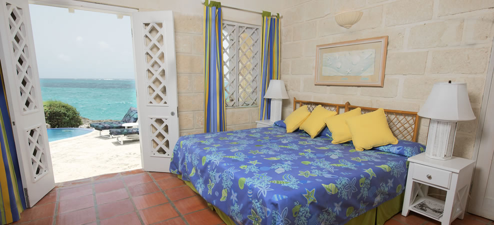 photo of wavecrest master bedroom with doors open to the beach