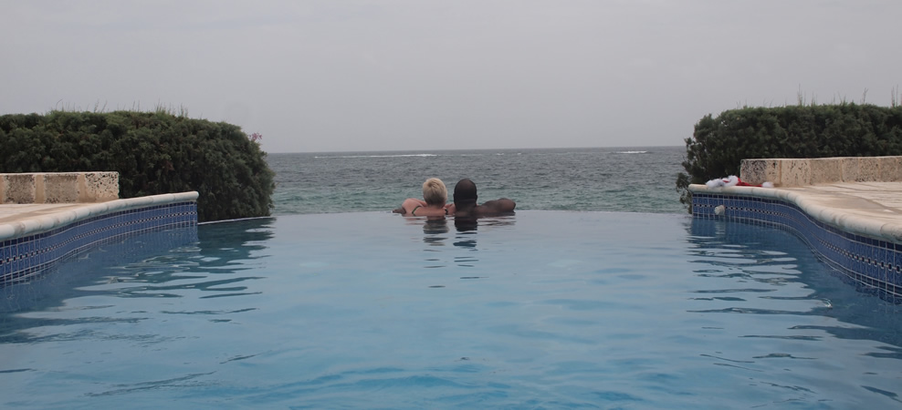 photo of couple looking out to sea in the infinity pool - next land in site is africa