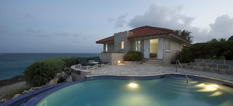 photo of wavecrest infinity pool at dusk with house in background